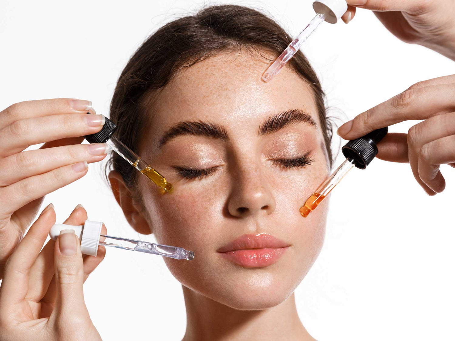Model applying skincare actives like retinol, vitamin C, and niacinamide, highlighting ingredient combinations for routines