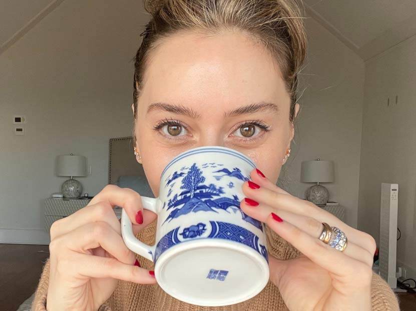 Dermatologist Dr. Shereene Idriss holding a mug while providing advice for sagging jowls