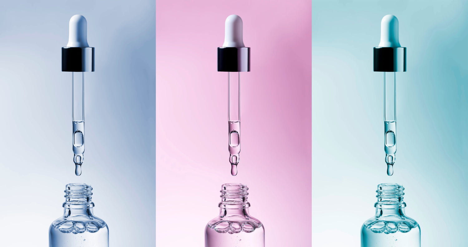 lue and pink bottles with a droppers showcasing serums, representing a Dermatologist’s retinol guide tailored to all budgets