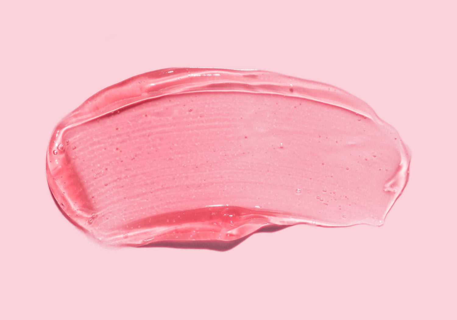 Pink gel texture against a matte-pink background, comparing various exfoliating acids’ abilities to reveal smoother and fresher skin