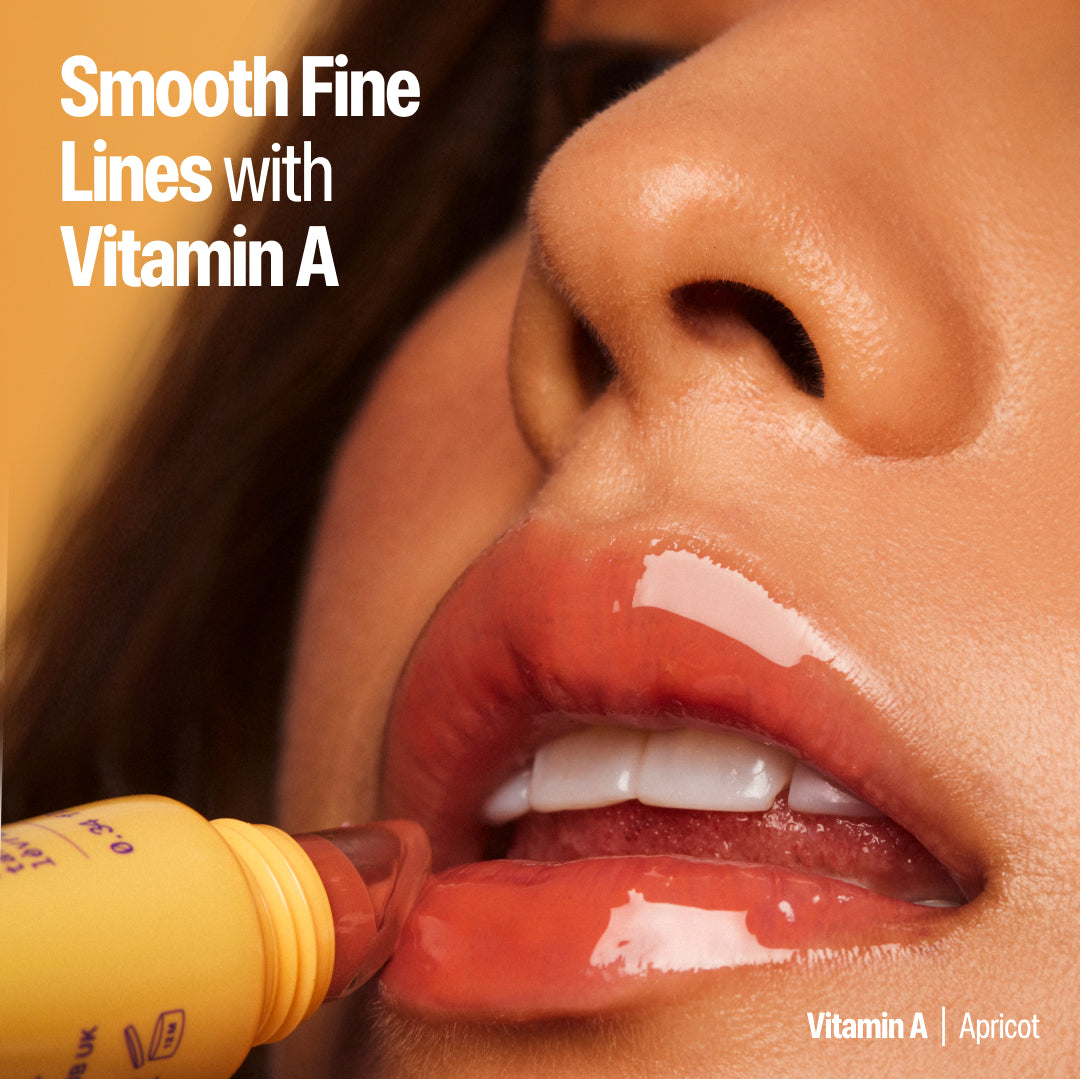 model applying the vitamin A apricot lip baste