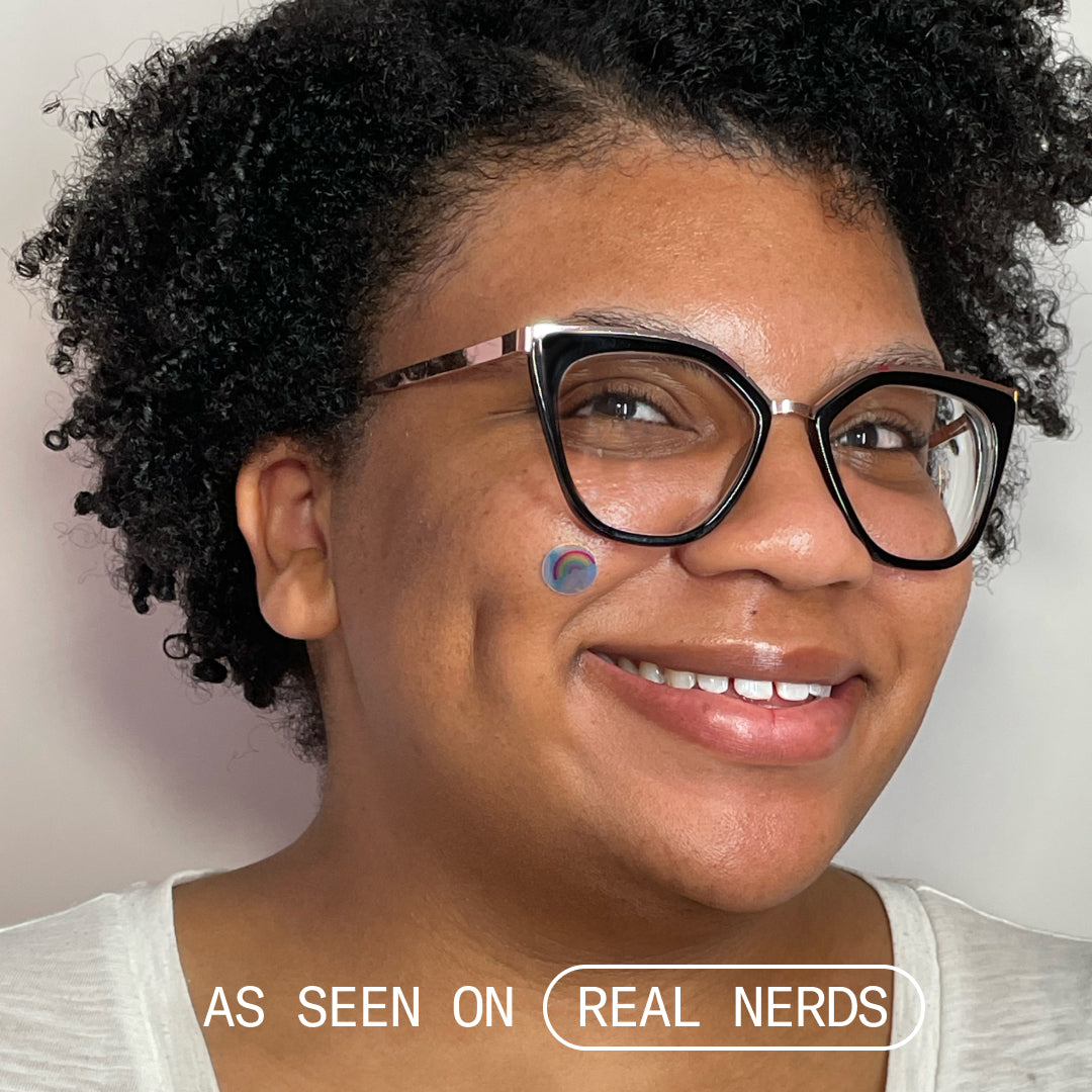 Another model wearing the rainbow patch on her cheek.