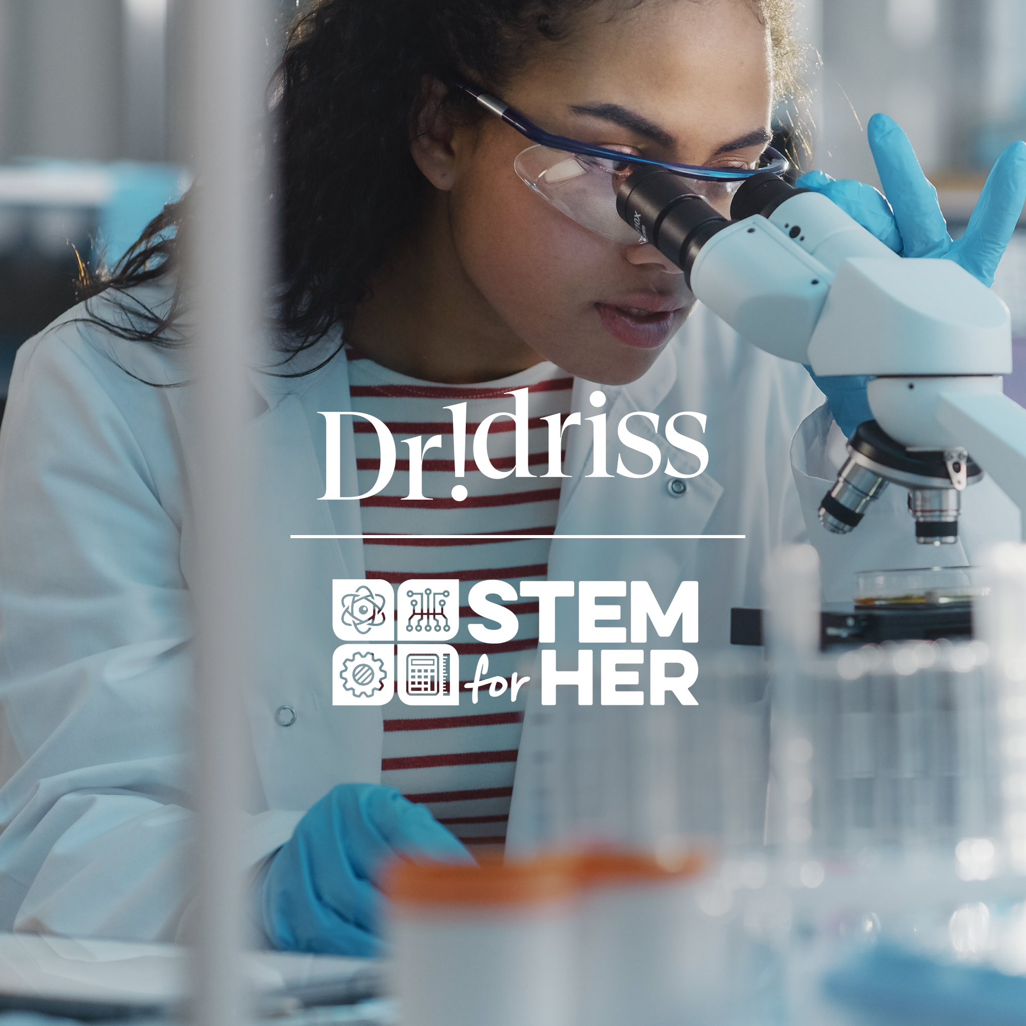 Female scientist looking into a microscope, highlighting Dr. Idriss’ longstanding relationship with STEM for HER
