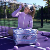 Dr. Shereene Idriss wearing the Major Shade Full Lux Sunshield in White on a tennis court and applying Major Fade Hyper Serum to her face