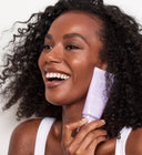 model holding the Major Fade Flash Mask and smiling