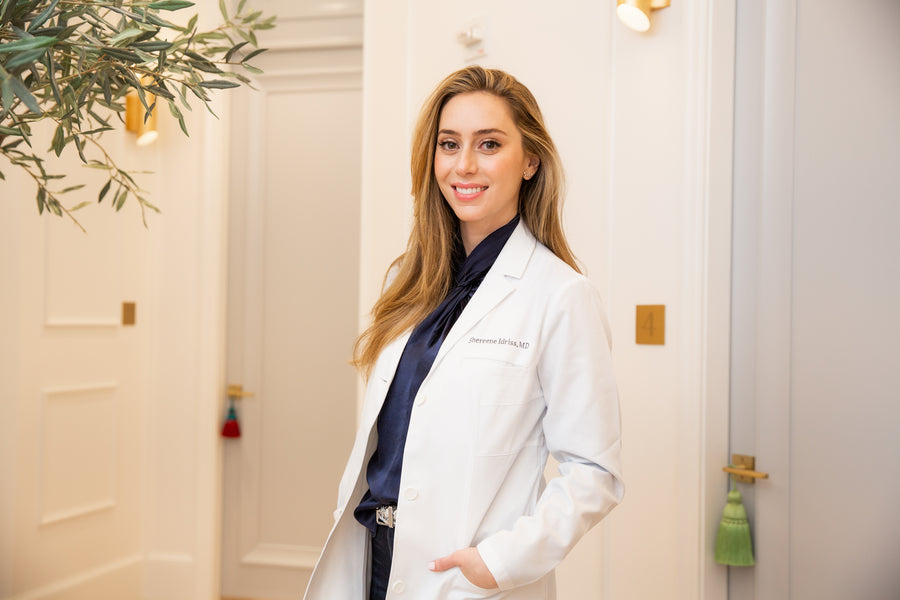 Dr. Shereene Idriss, board-certified dermatologist, in her white lab coat